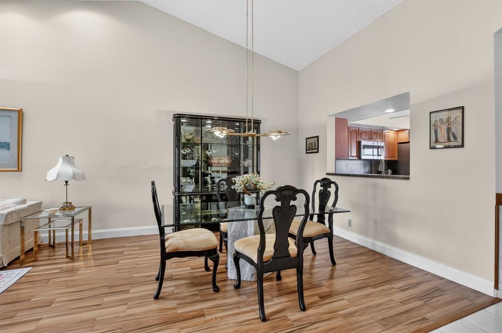7873 La Mirada Drive, Unit 7873 Boca Raton, FL 33433 - Photo 9 of 40 a dining room with furniture and wooden floor