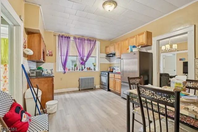 a kitchen that has a lot of cabinets a sink and a dining table