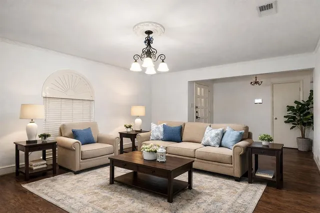 a living room with furniture and a chandelier