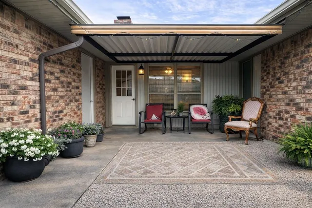 a living room filled with furniture and a potted plant
