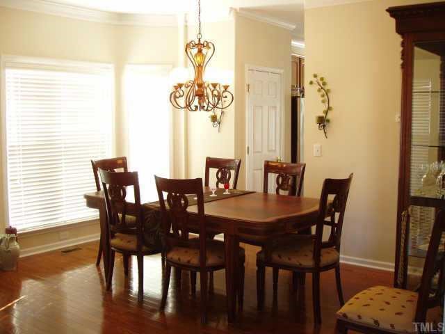 10632 Friendly Neighbor Lane Raleigh, NC 27614 - Photo 4 of 12 Have a seat! Formal dinning room with bay window and chandelier matching the foyer light.