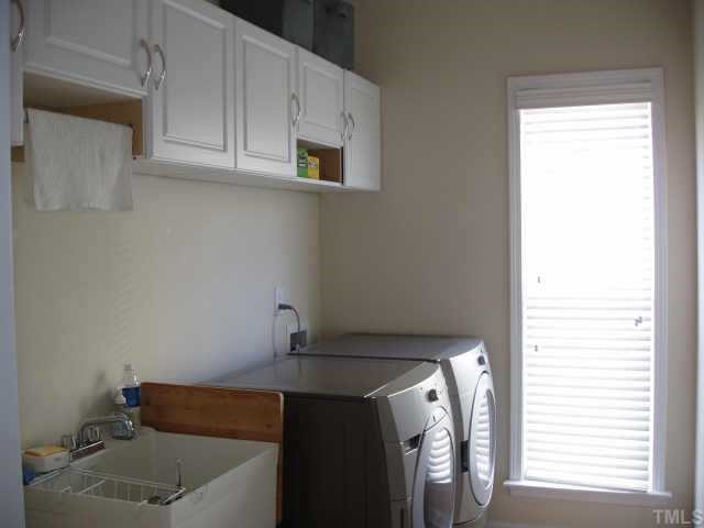10632 Friendly Neighbor Lane Raleigh, NC 27614 - Photo 8 of 12 There is a utility sink, there is a window, there are cabinets on the wall and it goes right out to garage, Perfect Laundry Room!