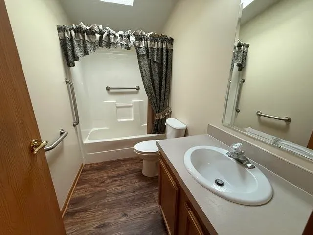 a bathroom with a sink toilet and shower