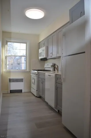 a kitchen with a white cabinets and white appliances