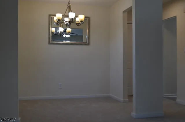 a room that has a window in it and a chandelier fan