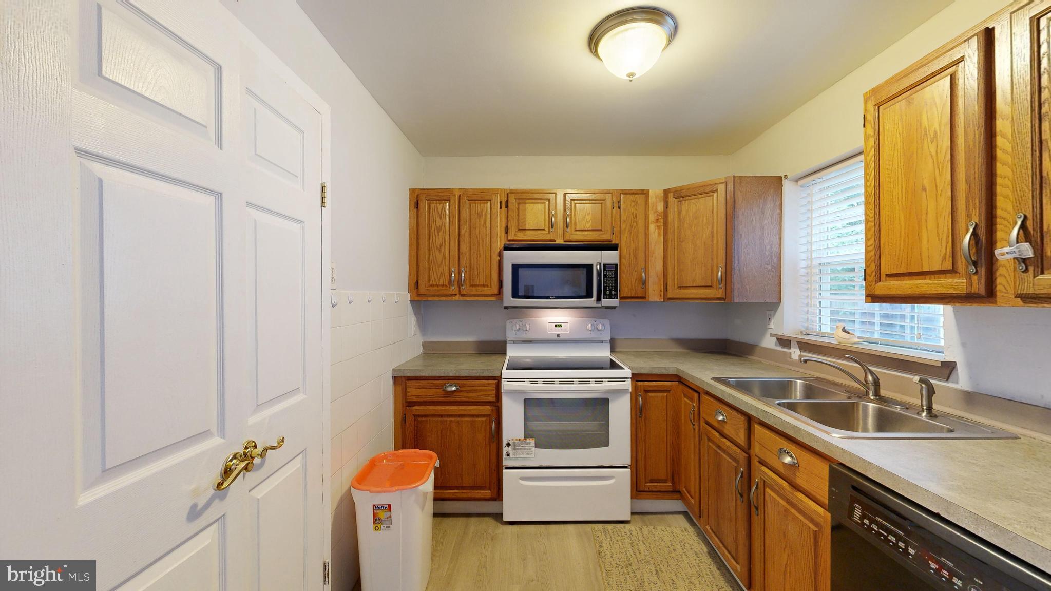 13 Teal Circle Newark, DE 19702 - Photo 9 of 29 a kitchen with a sink stove and microwave