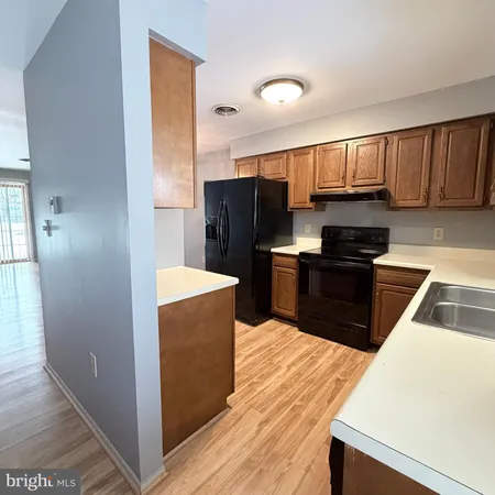 a kitchen with granite countertop a refrigerator and a stove