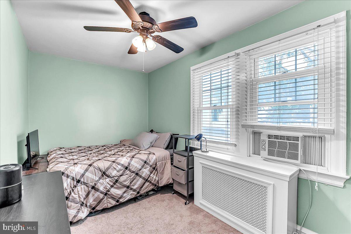 247 Sagamore Road Havertown, PA 19083 - Photo 25 of 41 a bedroom with a bed next to a window with a chandelier
