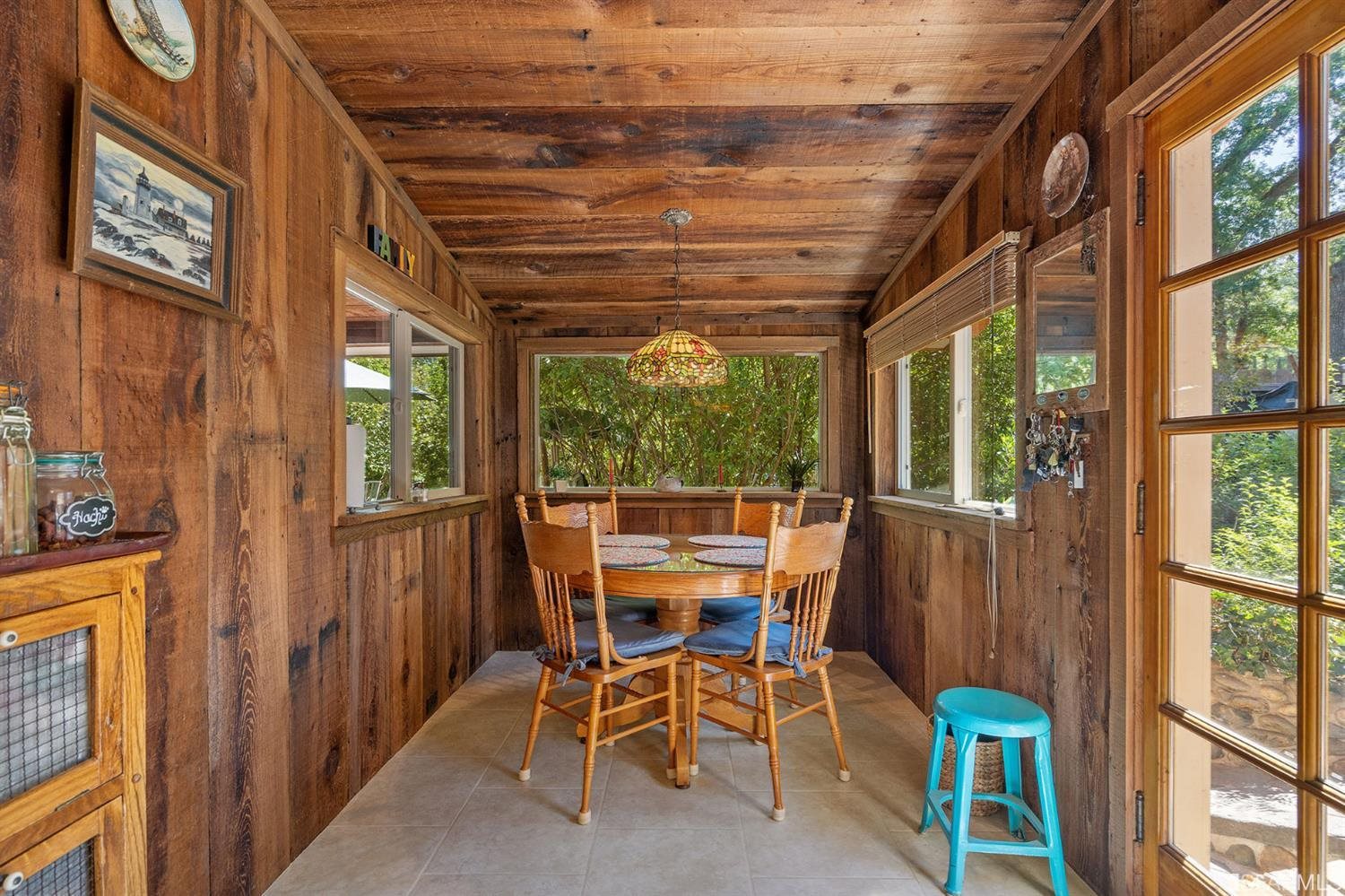 201 Castle Hill Ranch Road Walnut Creek, CA 94595 - Photo 21 of 44 a dining room with furniture and a floor to ceiling window