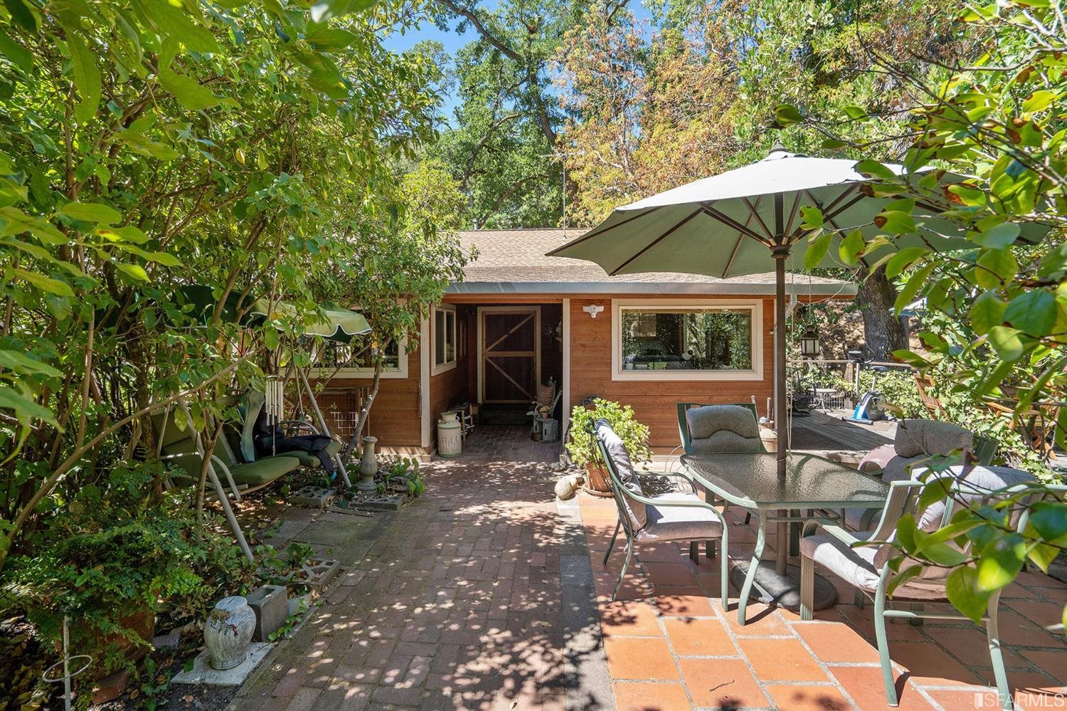 201 Castle Hill Ranch Road Walnut Creek, CA 94595 - Photo 7 of 44 a patio with table and chairs under an umbrella