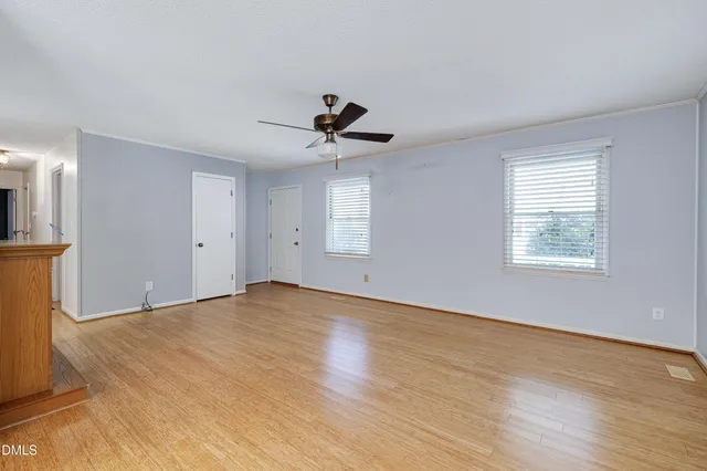 an empty room with closet and a window