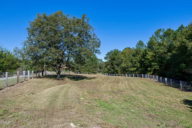 an aerial view of a house with a swimming pool yard and outdoor seating