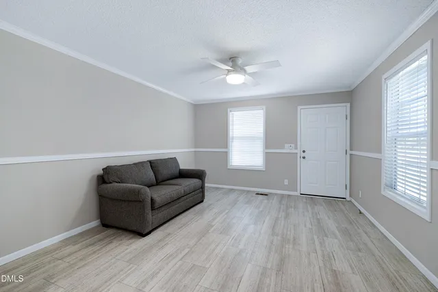 a view of a wooden fence under a large tree