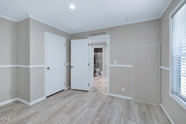 a view of a field with trees in the background
