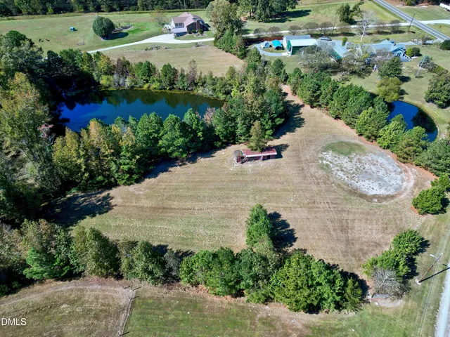 a view of empty room with wooden floor and fireplace