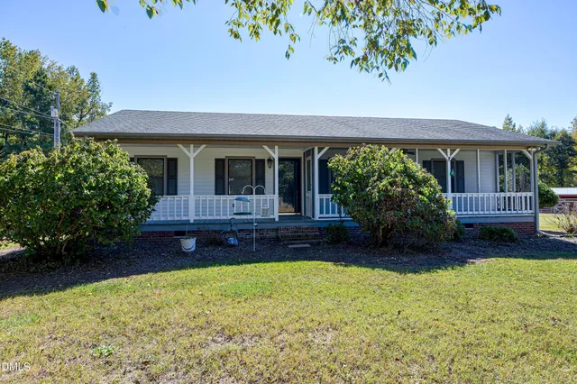 a kitchen with stainless steel appliances granite countertop a refrigerator a stove a sink cabinets and wooden floor