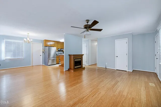 a bedroom with a bed and a flat tv screen on a dresser