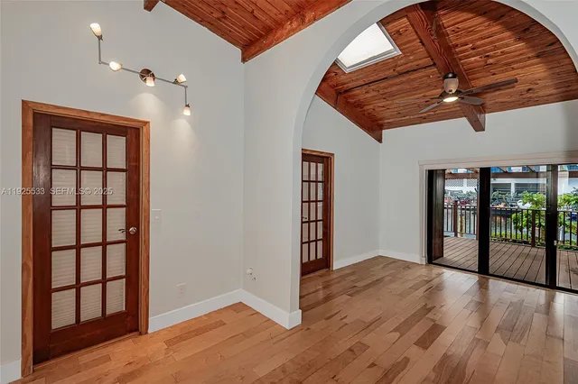 wooden floor in an empty room with a window