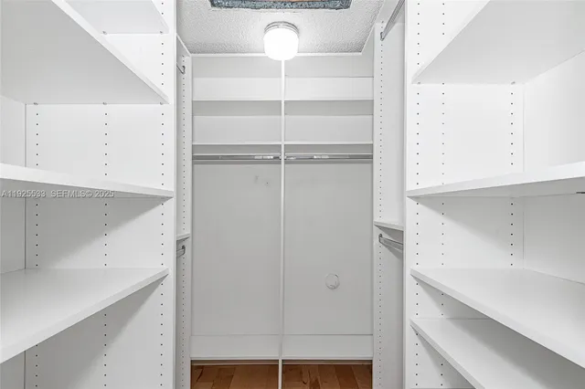 a view of cabinets and utility room with closet