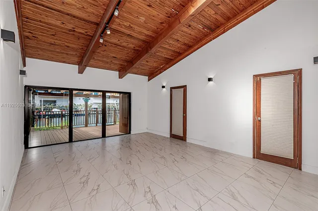 a view of an empty room with windows