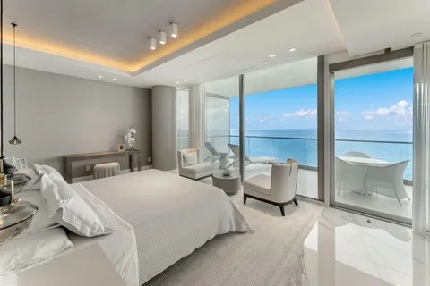 a bedroom with furniture and a large window