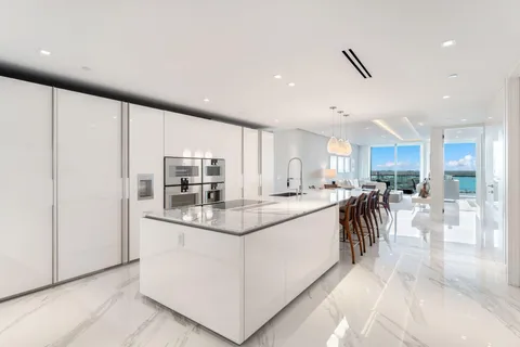 a kitchen with stainless steel appliances granite countertop a refrigerator and a stove