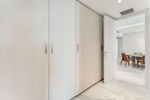 a living room with furniture tv and a floor to ceiling window