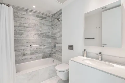 a bathroom with a toilet and a mirror