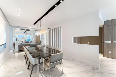 a dining room with furniture and a wooden floor