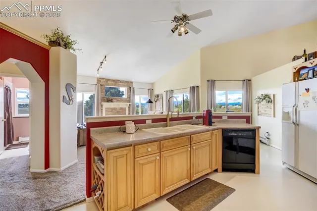 a kitchen with stainless steel appliances granite countertop a sink and cabinets