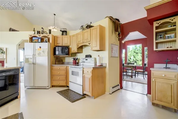 a kitchen with refrigerator and cabinets
