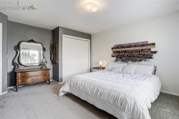 a bedroom with a bed and a dresser