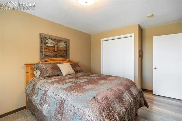 a bedroom with a bed and a painting on the wall