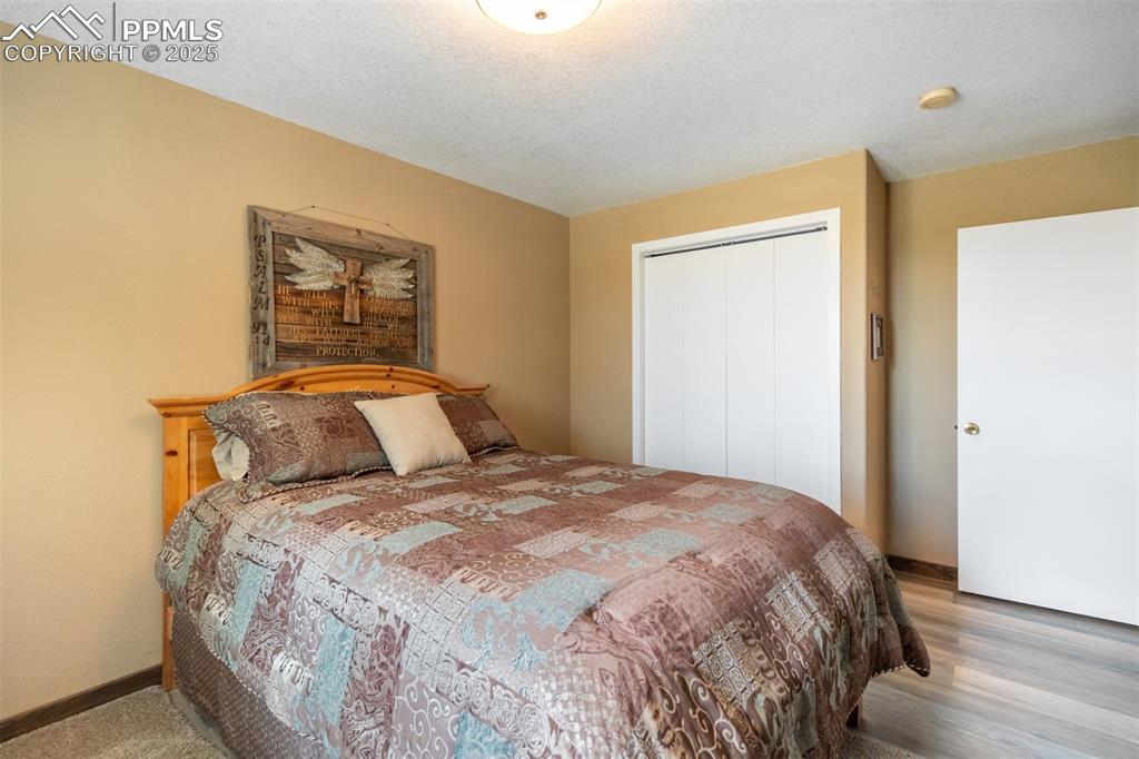 6275 Meridian Road Peyton, CO 80831 - Photo 28 of 50 a bedroom with a bed and a painting on the wall