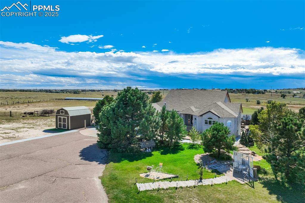 6275 Meridian Road Peyton, CO 80831 - Photo 3 of 50 a view of a yard with an ocean view