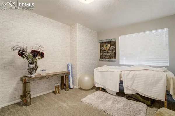 a bedroom with a bed and a table