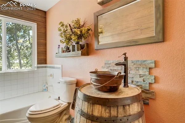 a bathroom with a toilet a sink and a window