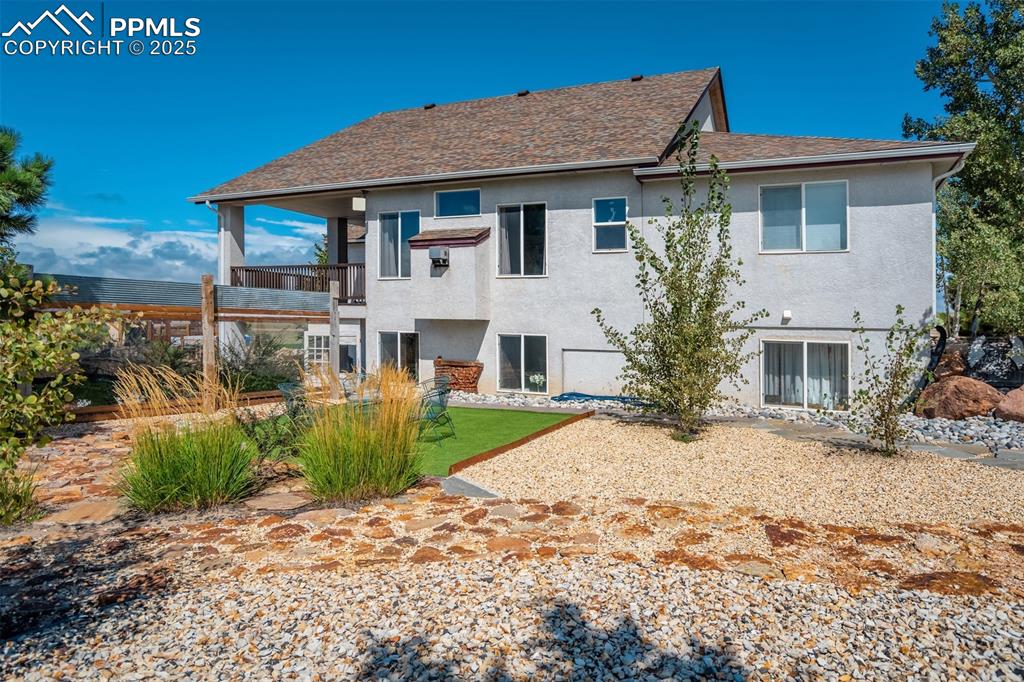 6275 Meridian Road Peyton, CO 80831 - Photo 38 of 50 a view of a white house with a yard