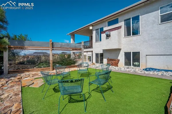 a view of house with backyard and patio