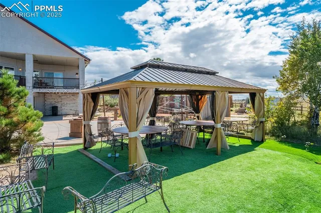 a view of house with swimming pool outdoor seating area and garden