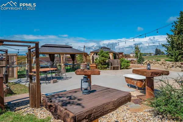 a view of a backyard with sitting area