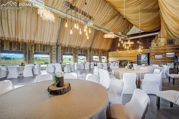 a dining room with furniture and wooden floor