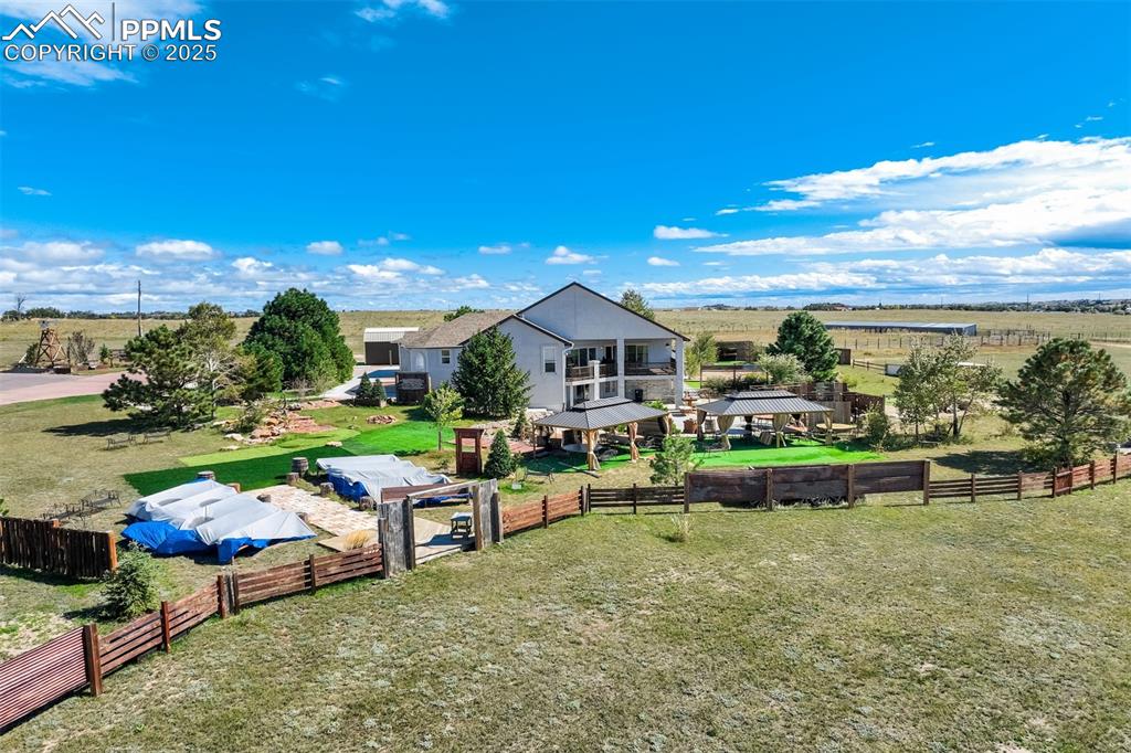 6275 Meridian Road Peyton, CO 80831 - Photo 49 of 50 a roof deck with table and chairs a fire pit