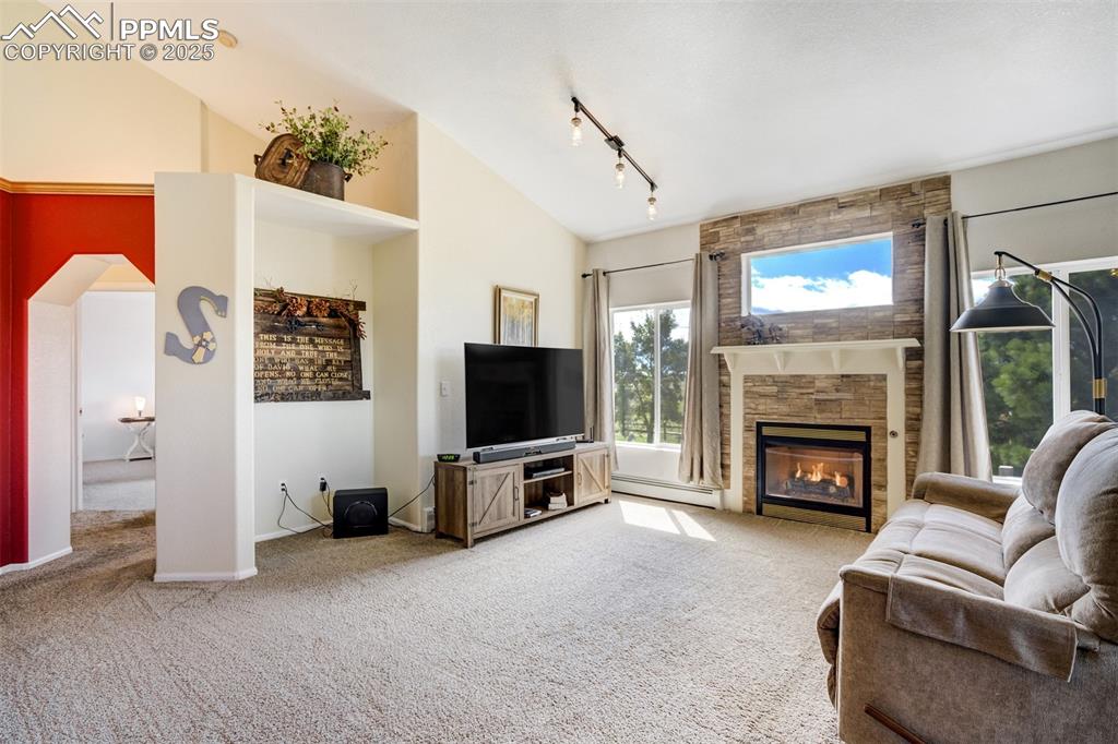 6275 Meridian Road Peyton, CO 80831 - Photo 6 of 50 a living room with furniture a flat screen tv and a fireplace