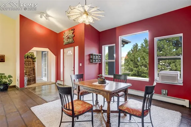 a dining room with furniture a window and a chandelier