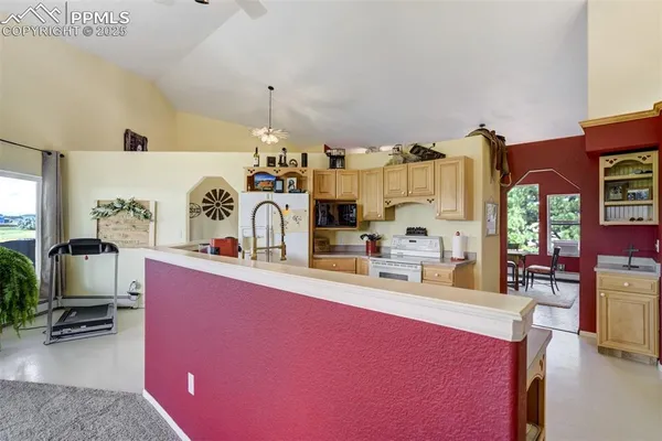 a kitchen with granite countertop a sink cabinets and appliances