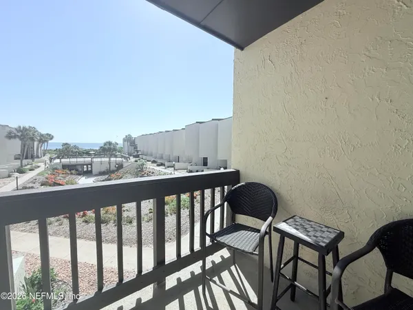 a view of a balcony with chairs