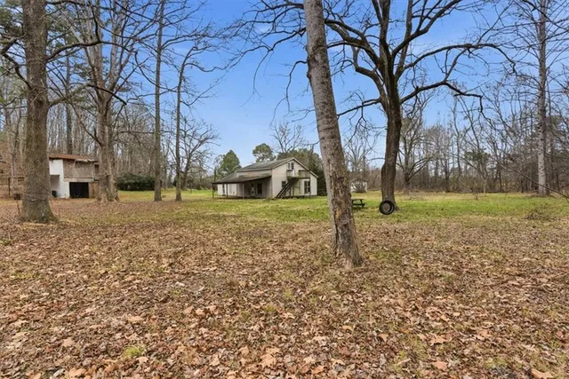 a view of a yard with a house and a tree