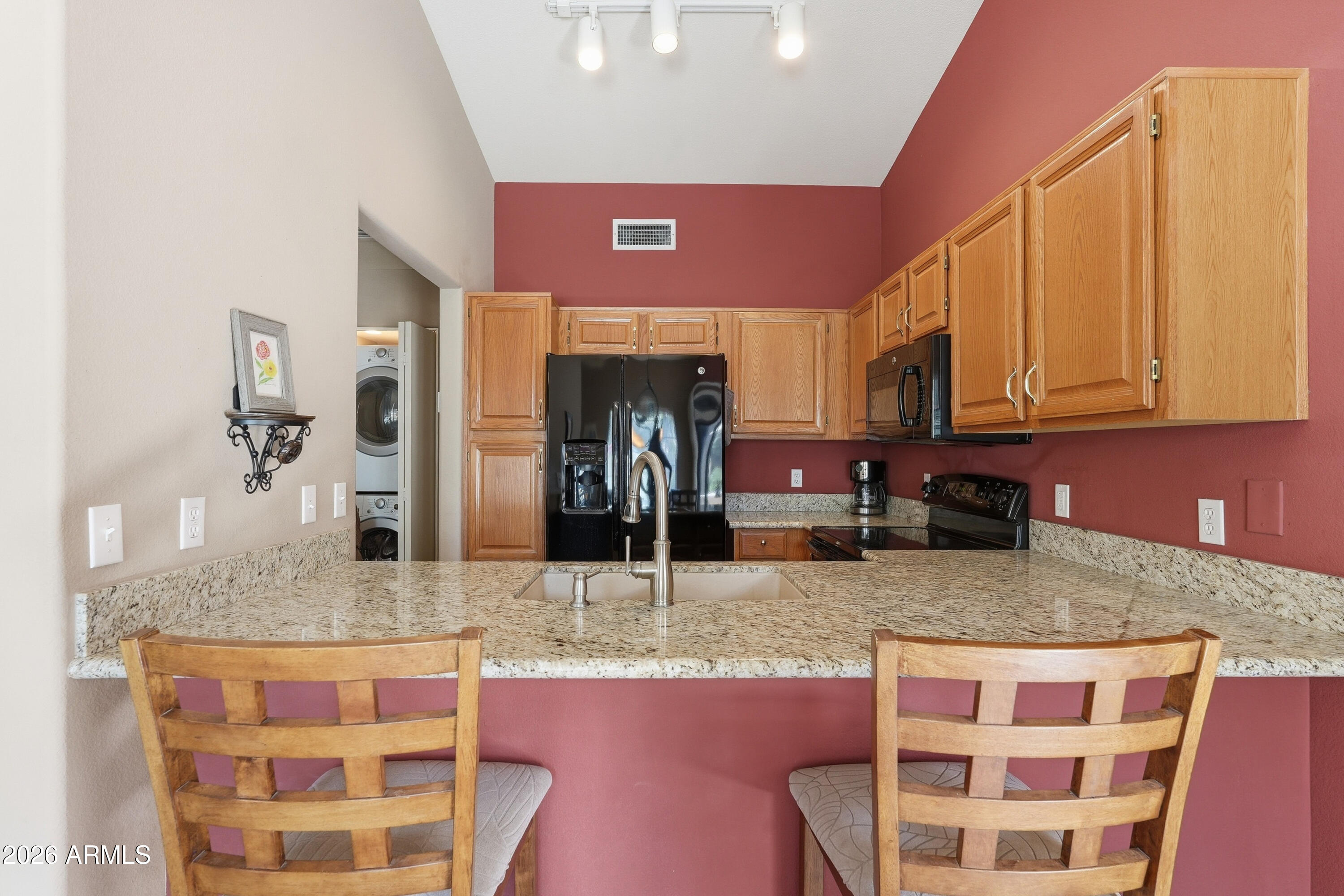 14300 West Bell Road, Unit 387 Surprise, AZ 85374 - Photo 6 of 18 a kitchen with stainless steel appliances granite countertop a sink and cabinets
