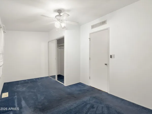 a view of an empty room with a fan